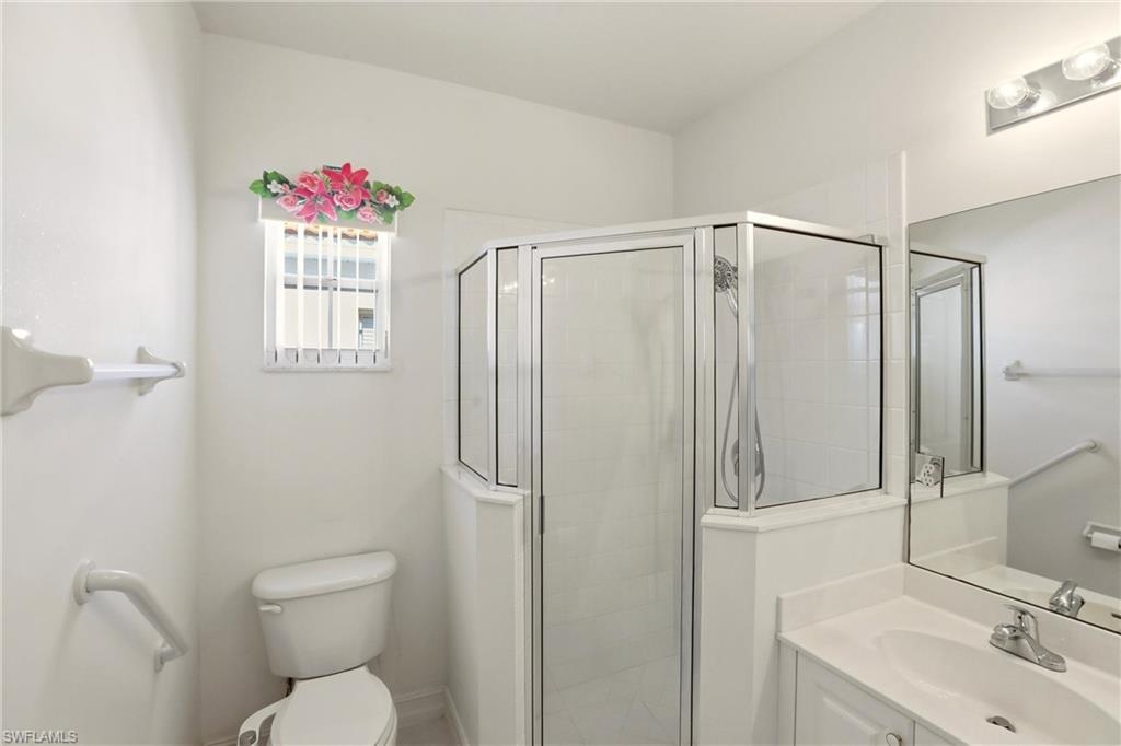 511 Joseph Court, Unit 2 Naples, FL 34104 - Photo 32 of 50 a bathroom with a sink toilet and shower