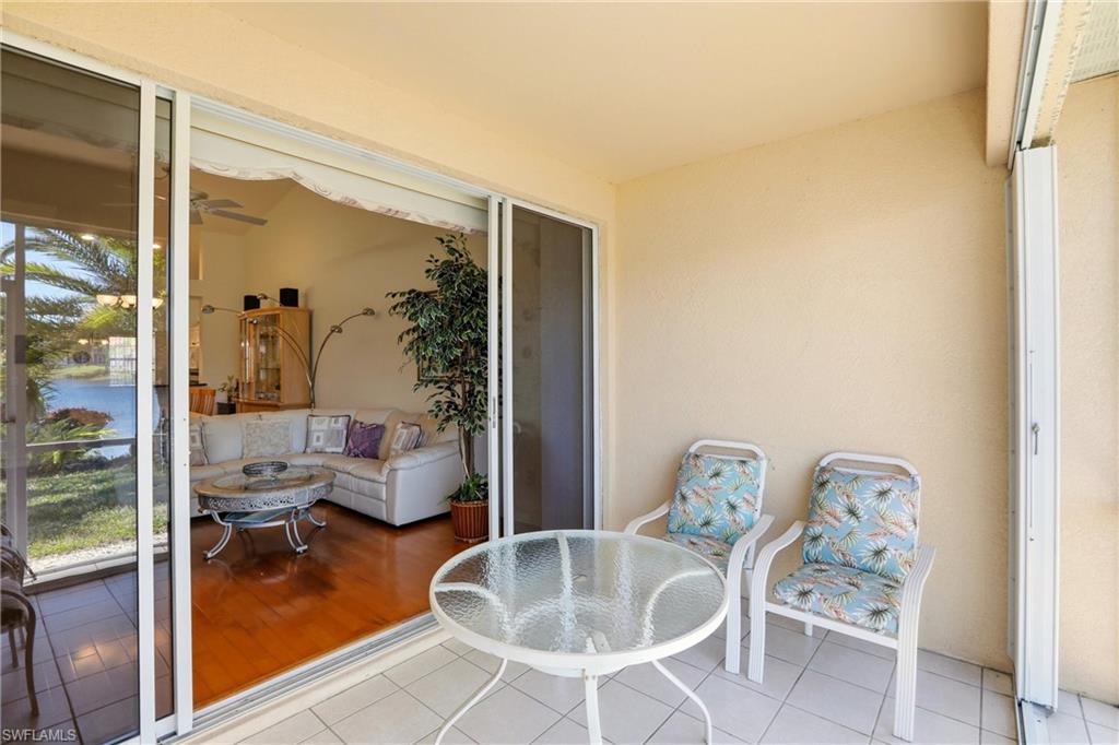 511 Joseph Court, Unit 2 Naples, FL 34104 - Photo 39 of 50 a dining room with furniture and a floor to ceiling window