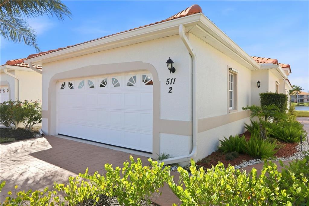 511 Joseph Court, Unit 2 Naples, FL 34104 - Photo 4 of 50 a front view of a house with plants