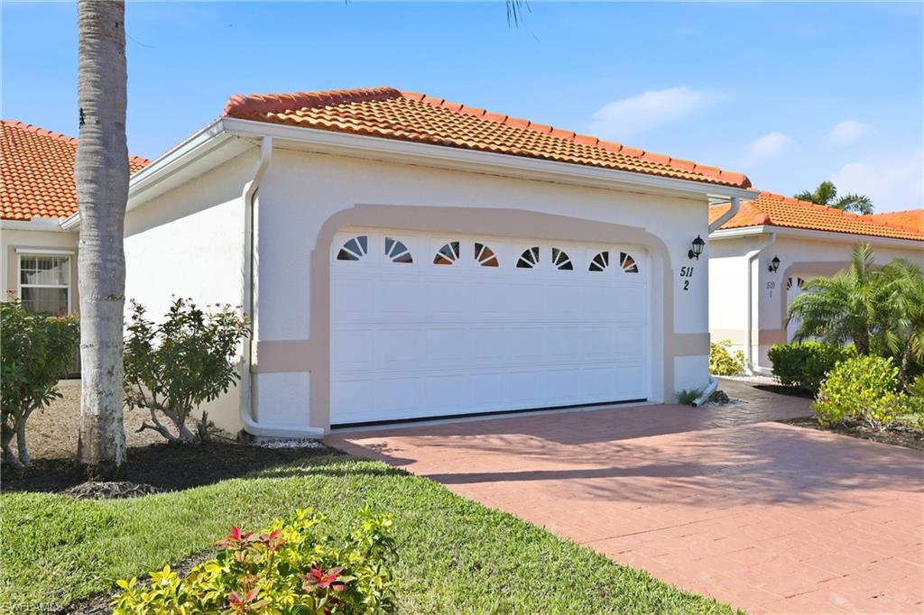 511 Joseph Court, Unit 2 Naples, FL 34104 - Photo 6 of 50 a front view of house with yard