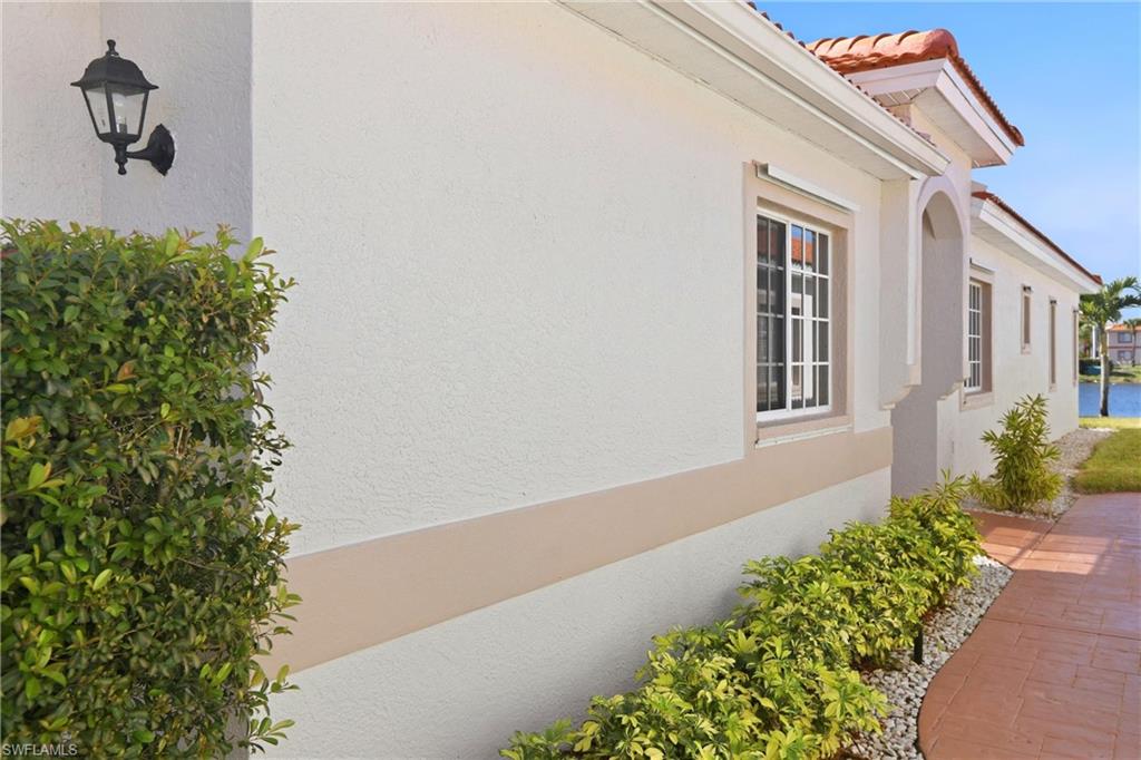 511 Joseph Court, Unit 2 Naples, FL 34104 - Photo 7 of 50 a front view of a house with a yard