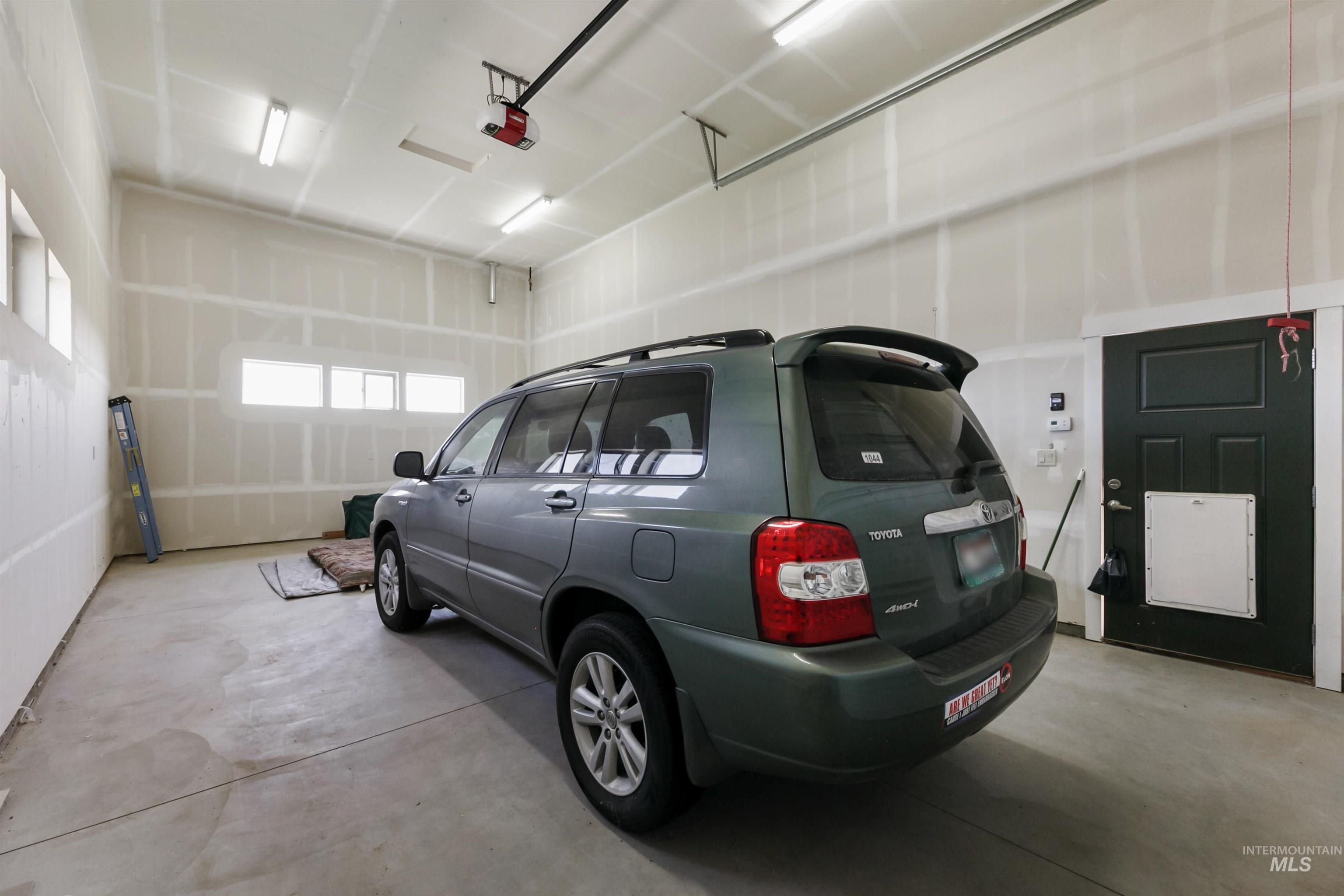 24398 Tombstone Ridge Court Middleton, ID 83644 - Photo 43 of 47 Spacious garage featuring concrete flooring, unpainted drywall, and ample natural light from multiple horizontal windows