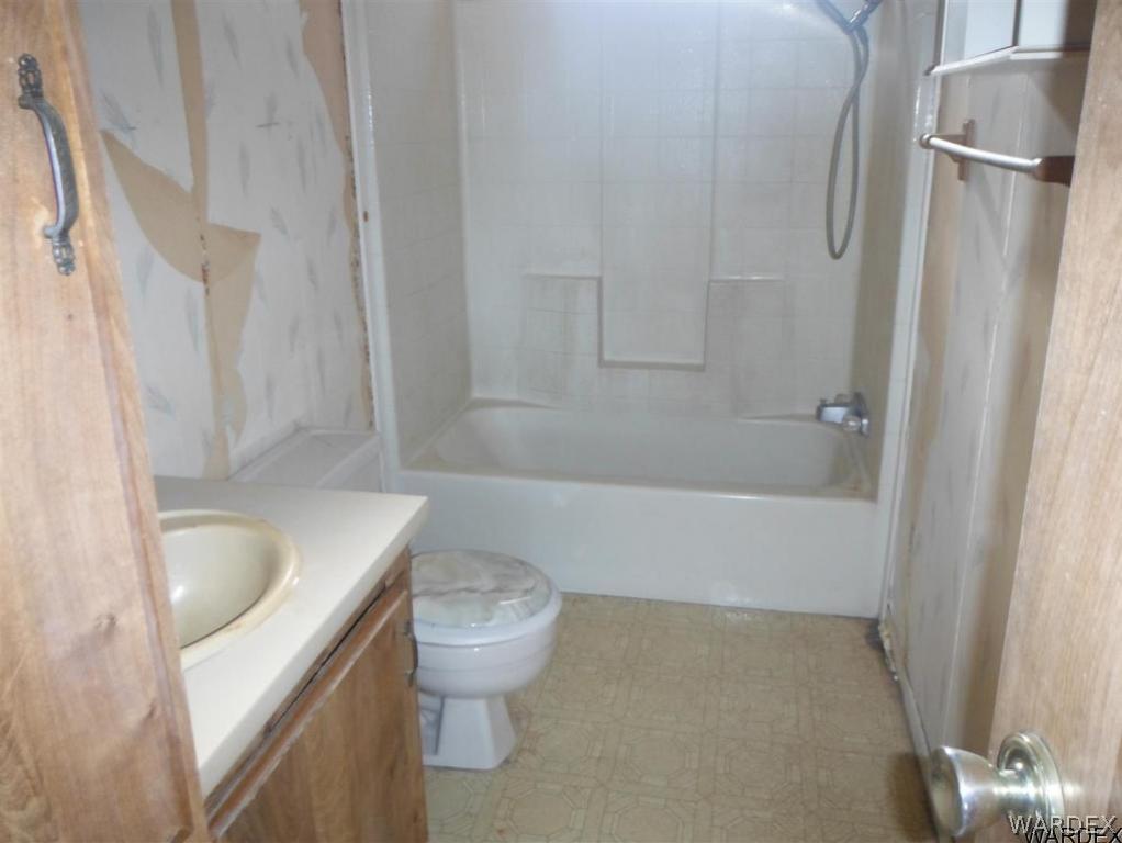 3572 Salt Road Golden Valley, AZ 86413 - Photo 15 of 17 a bathroom with a granite countertop bathtub shower sink vanity and toilet