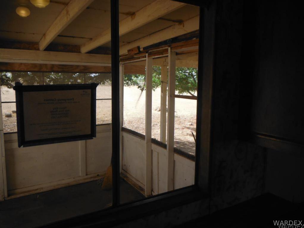 3572 Salt Road Golden Valley, AZ 86413 - Photo 17 of 17 a view of an empty room with wooden floor and a window