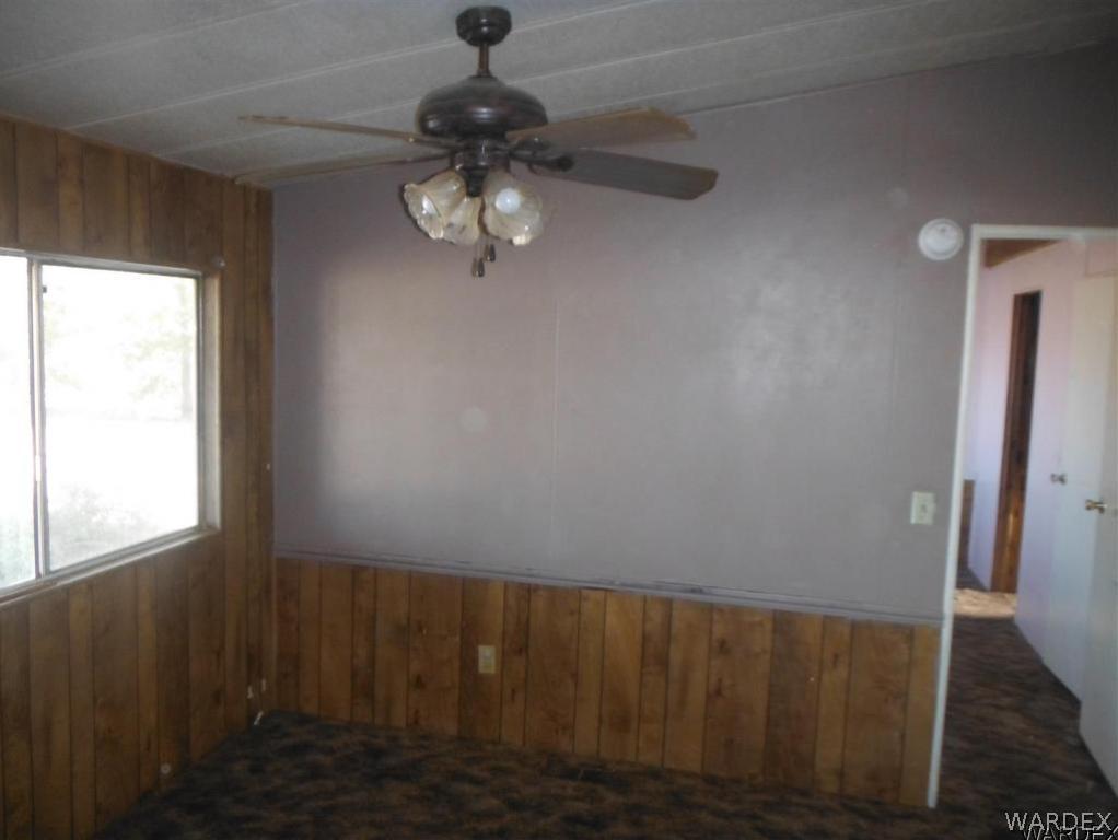 3572 Salt Road Golden Valley, AZ 86413 - Photo 7 of 17 en empty room with wooden floor and window