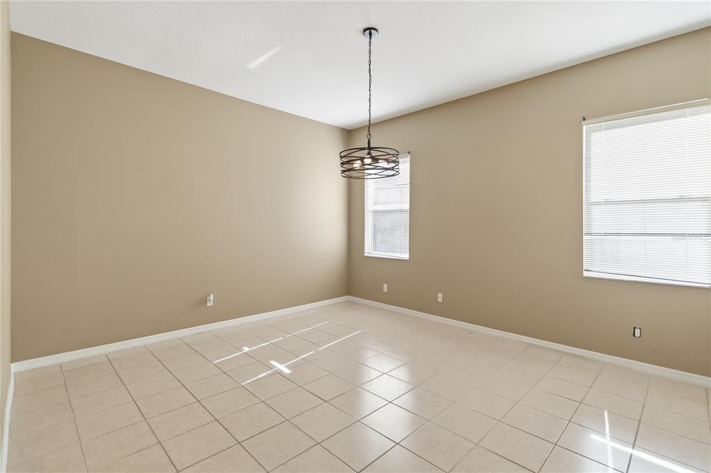 677 Buckhaven Loop Ocoee, FL 34761 - Photo 14 of 41 a view of a room with window and chandelier fan