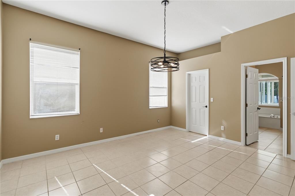 677 Buckhaven Loop Ocoee, FL 34761 - Photo 16 of 41 a view of a livingroom with a chandelier fan and windows