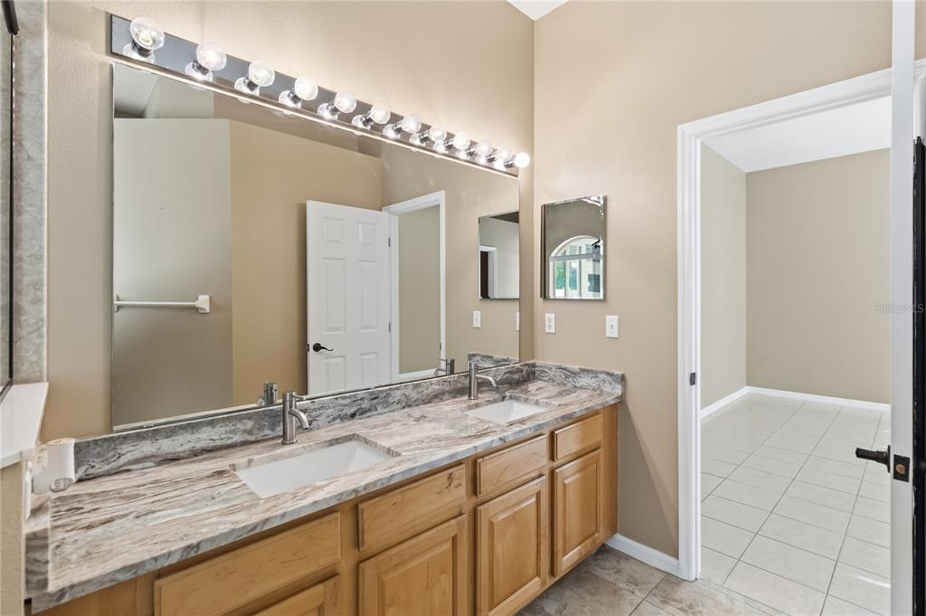 677 Buckhaven Loop Ocoee, FL 34761 - Photo 17 of 41 a bathroom with a granite countertop sink and a mirror