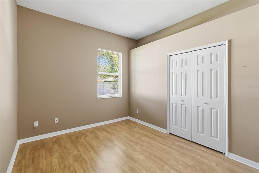 677 Buckhaven Loop Ocoee, FL 34761 - Photo 21 of 41 a view of an empty room with wooden floor and a window