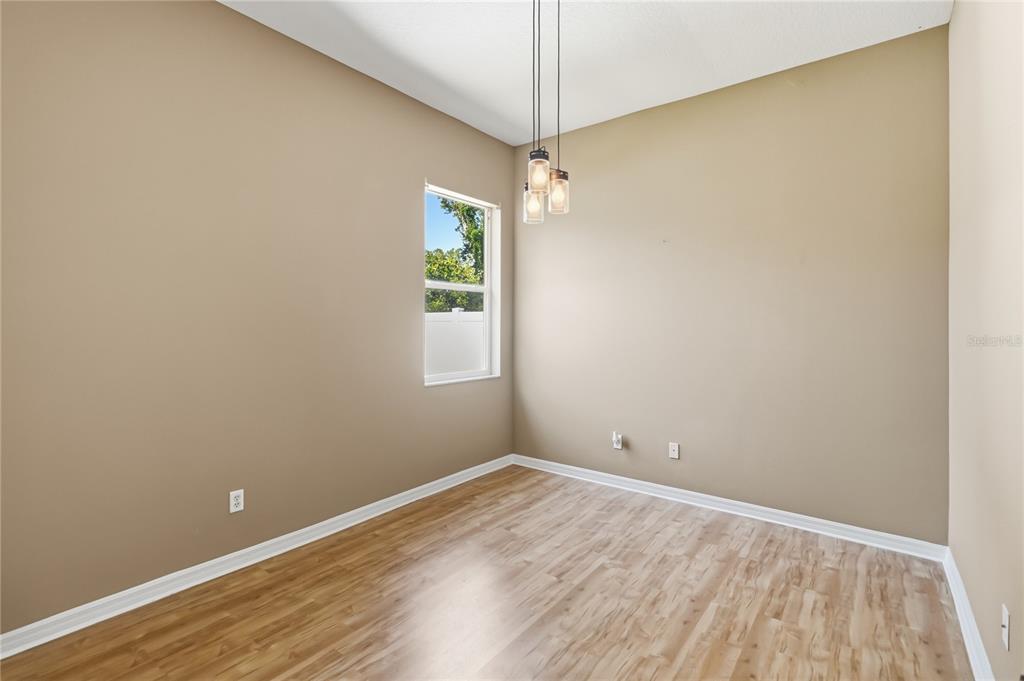 677 Buckhaven Loop Ocoee, FL 34761 - Photo 23 of 41 an empty room with a window and wooden floor