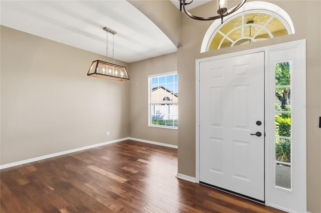677 Buckhaven Loop Ocoee, FL 34761 - Photo 3 of 41 a view of an entryway with wooden floor