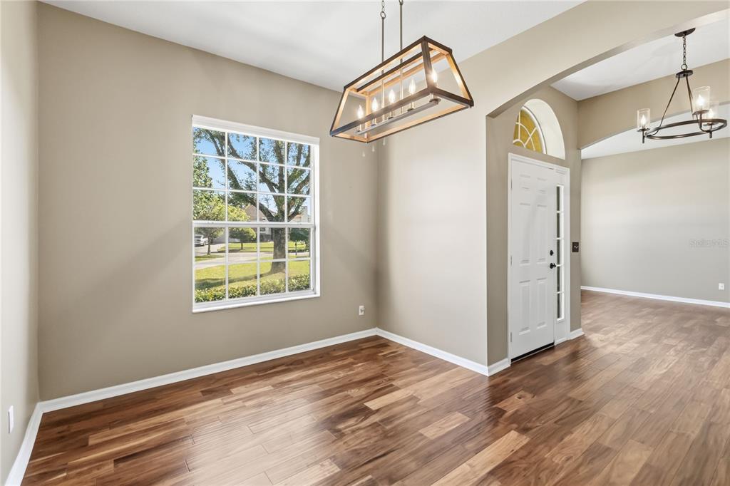 677 Buckhaven Loop Ocoee, FL 34761 - Photo 4 of 41 a view of a big room with wooden floor and windows