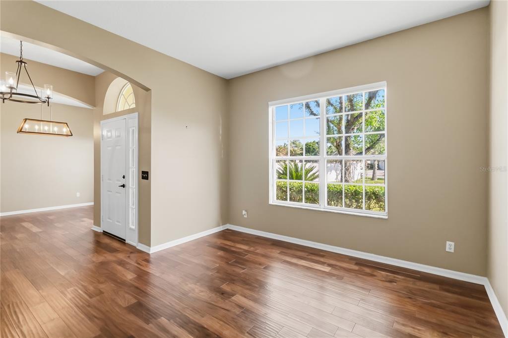 677 Buckhaven Loop Ocoee, FL 34761 - Photo 6 of 41 an empty room with wooden floor and windows