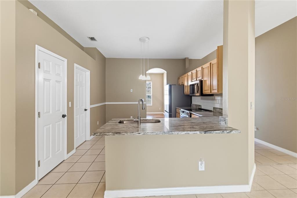 677 Buckhaven Loop Ocoee, FL 34761 - Photo 10 of 41 a view of a living room with kitchen island granite countertop furniture