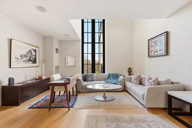 a living room with furniture a rug and a window
