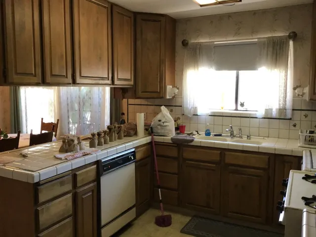 a kitchen with a sink cabinets and window