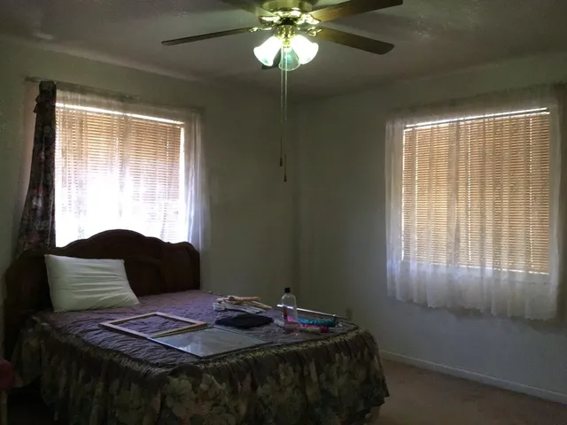 a bedroom with a bed and window