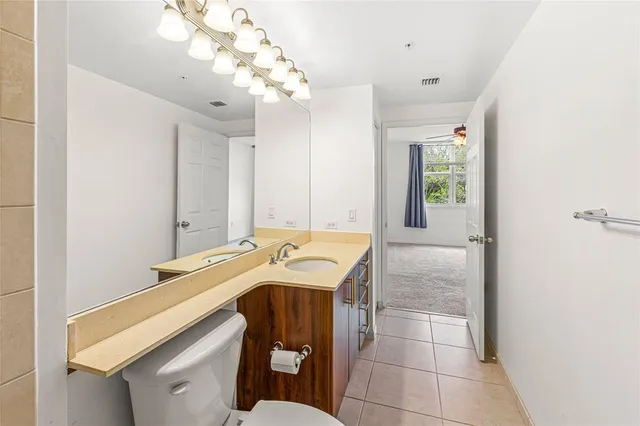 a bathroom with a sink a vanity and mirror