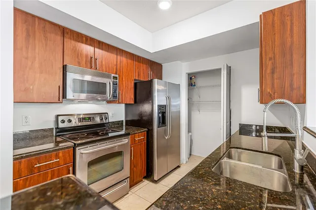 a kitchen with a sink cabinets and stainless steel appliances