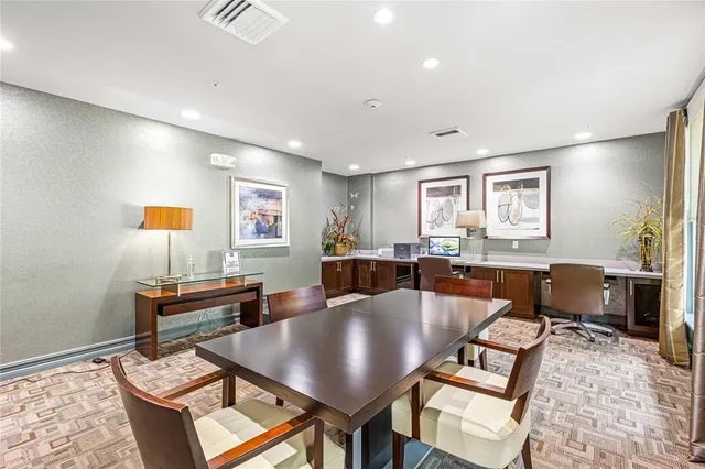 a living room with furniture kitchen view and a window
