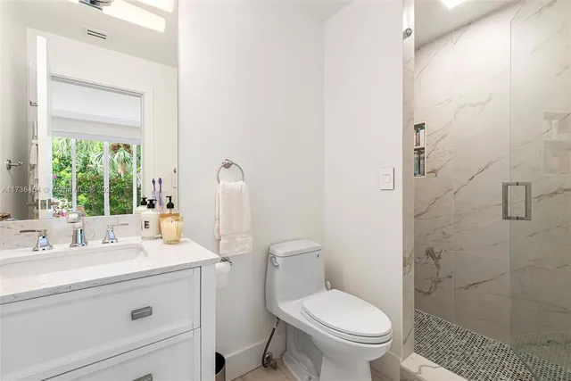 a large bed sitting in a bedroom next to a window