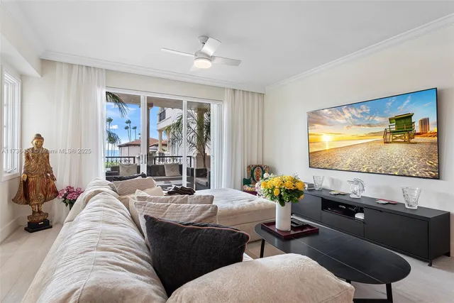 a view of a hallway to a livingroom with wooden floor and furniture