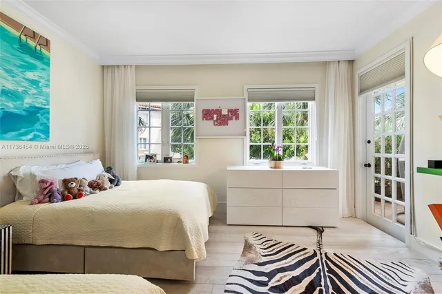 a bedroom with two beds and painting on the wall