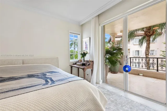 a spacious bedroom with a bed and glass window