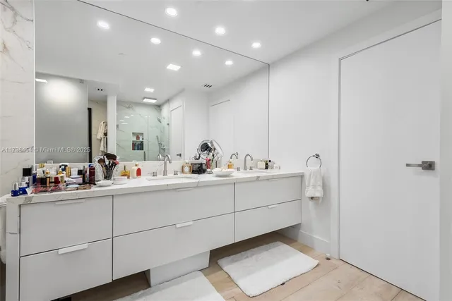 a bathroom with a sink mirror and toilet