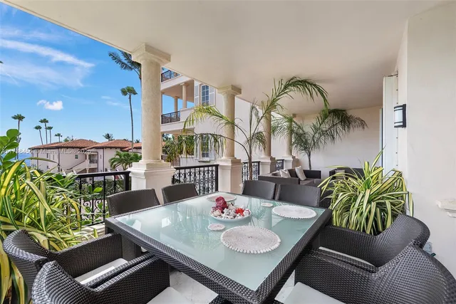 a dining room with furniture and a floor to ceiling window