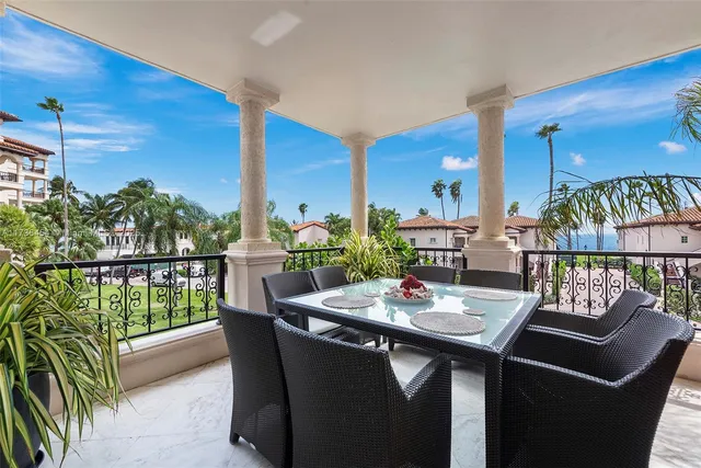 a living room with furniture a lamp and a potted plant