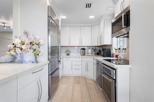 a kitchen with a sink stove and cabinets