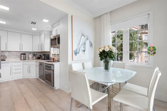 a kitchen with a table and chairs in it