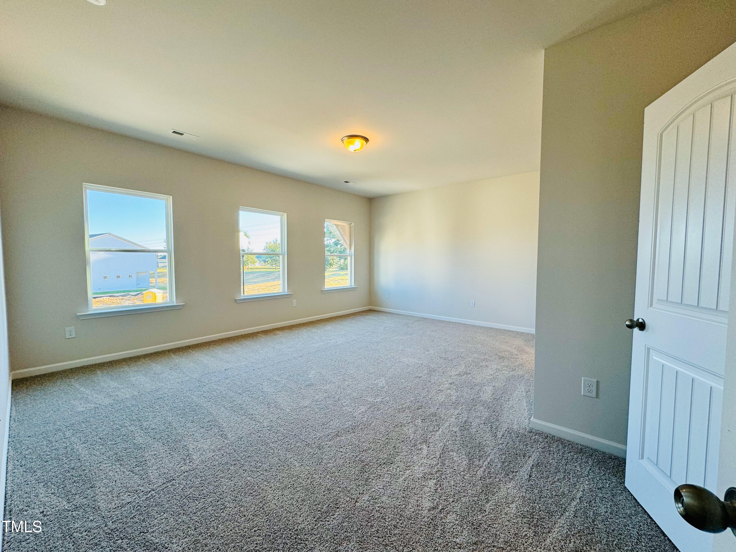 134 Commons Circle, Unit 232 Clayton, NC 27520 - Photo 12 of 37 an empty room with windows