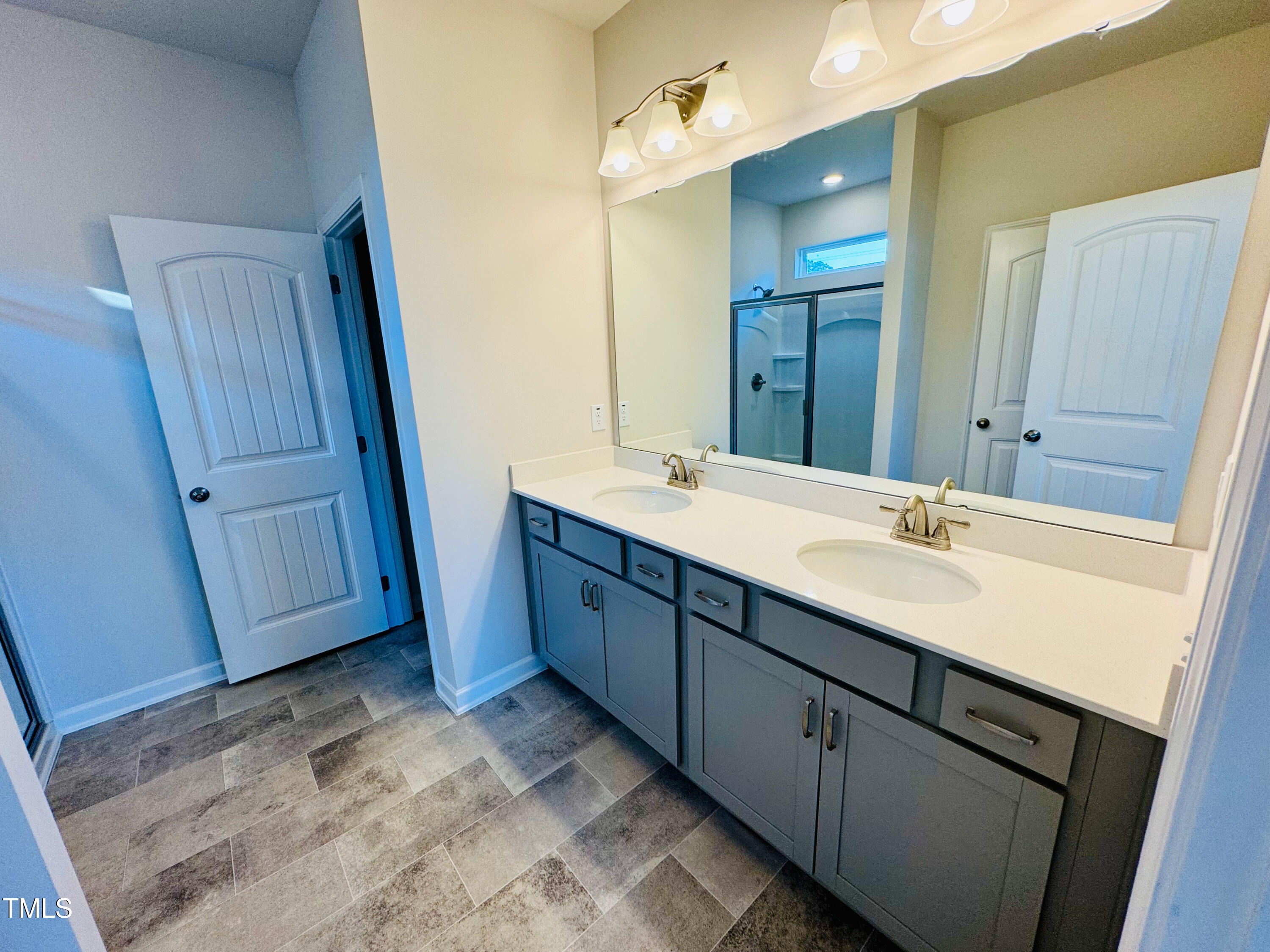 134 Commons Circle, Unit 232 Clayton, NC 27520 - Photo 15 of 37 a bathroom with a double vanity sink and mirror