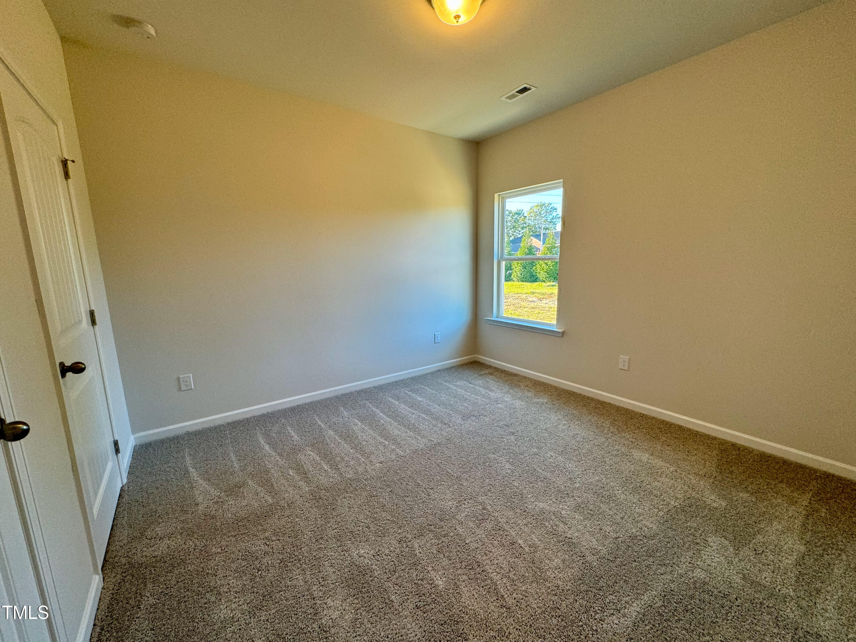 134 Commons Circle, Unit 232 Clayton, NC 27520 - Photo 16 of 37 an empty room with windows