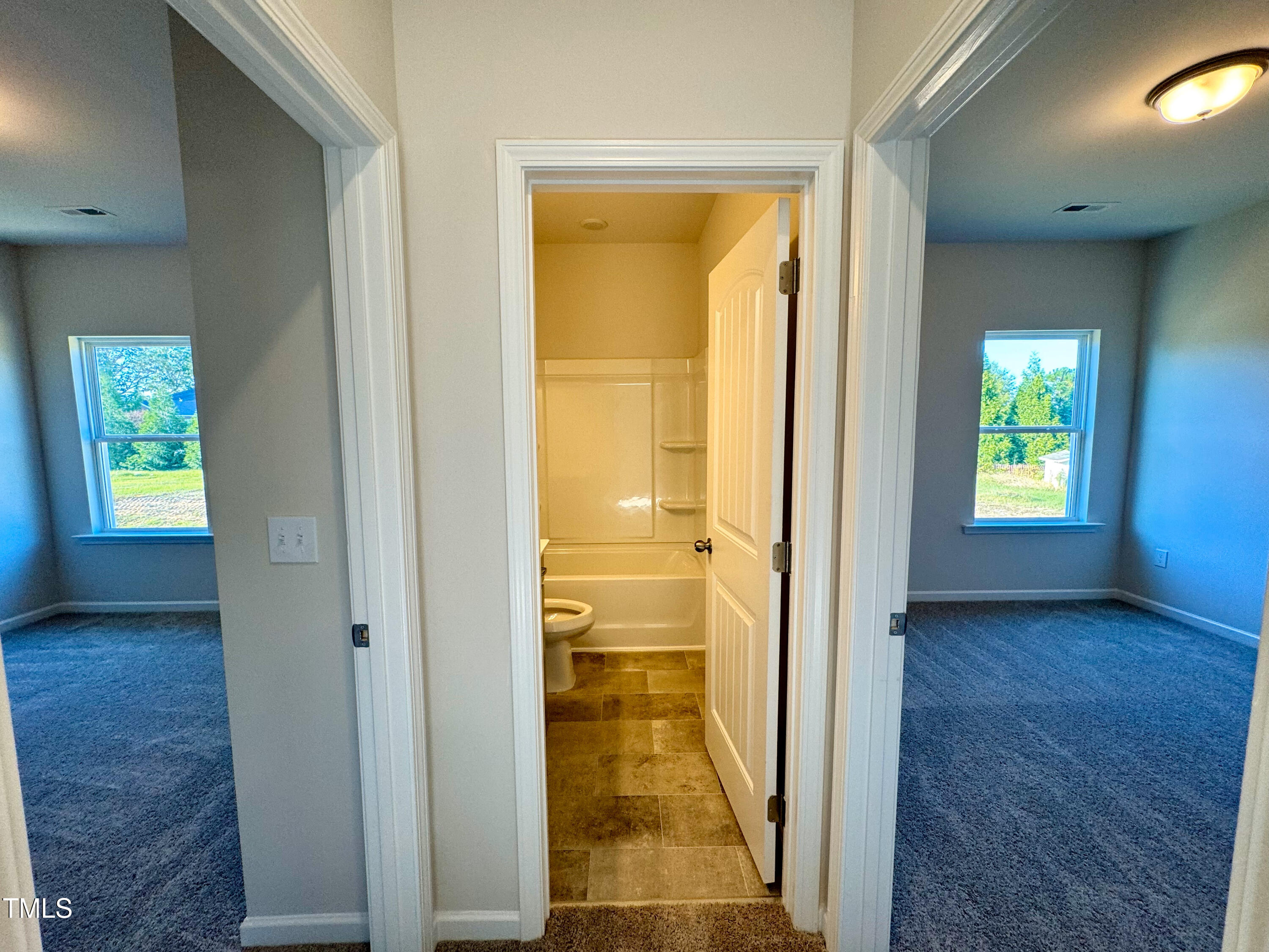 134 Commons Circle, Unit 232 Clayton, NC 27520 - Photo 17 of 37 a view of hallway with livingroom and wooden floor