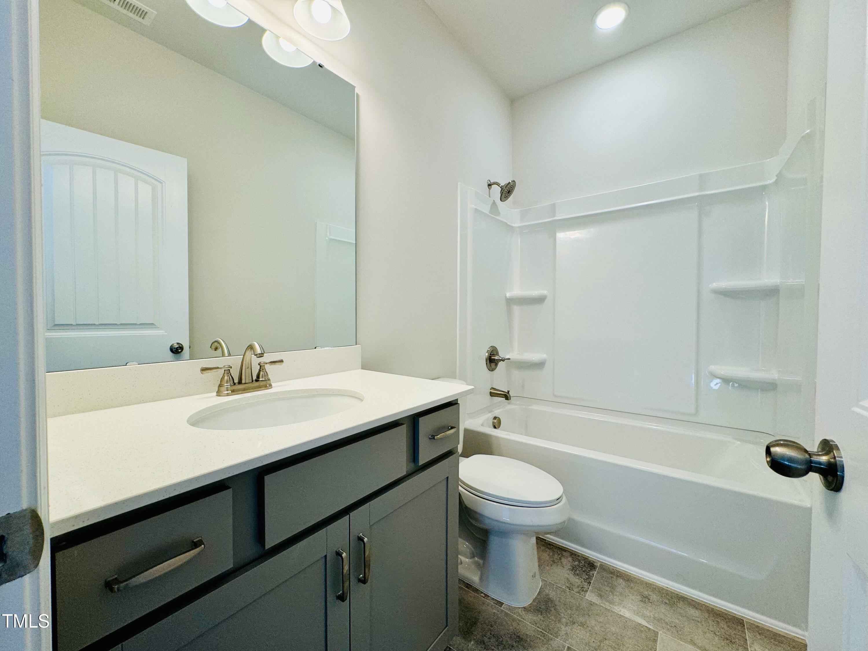 134 Commons Circle, Unit 232 Clayton, NC 27520 - Photo 19 of 37 a bathroom with a sink a toilet and a bathtub