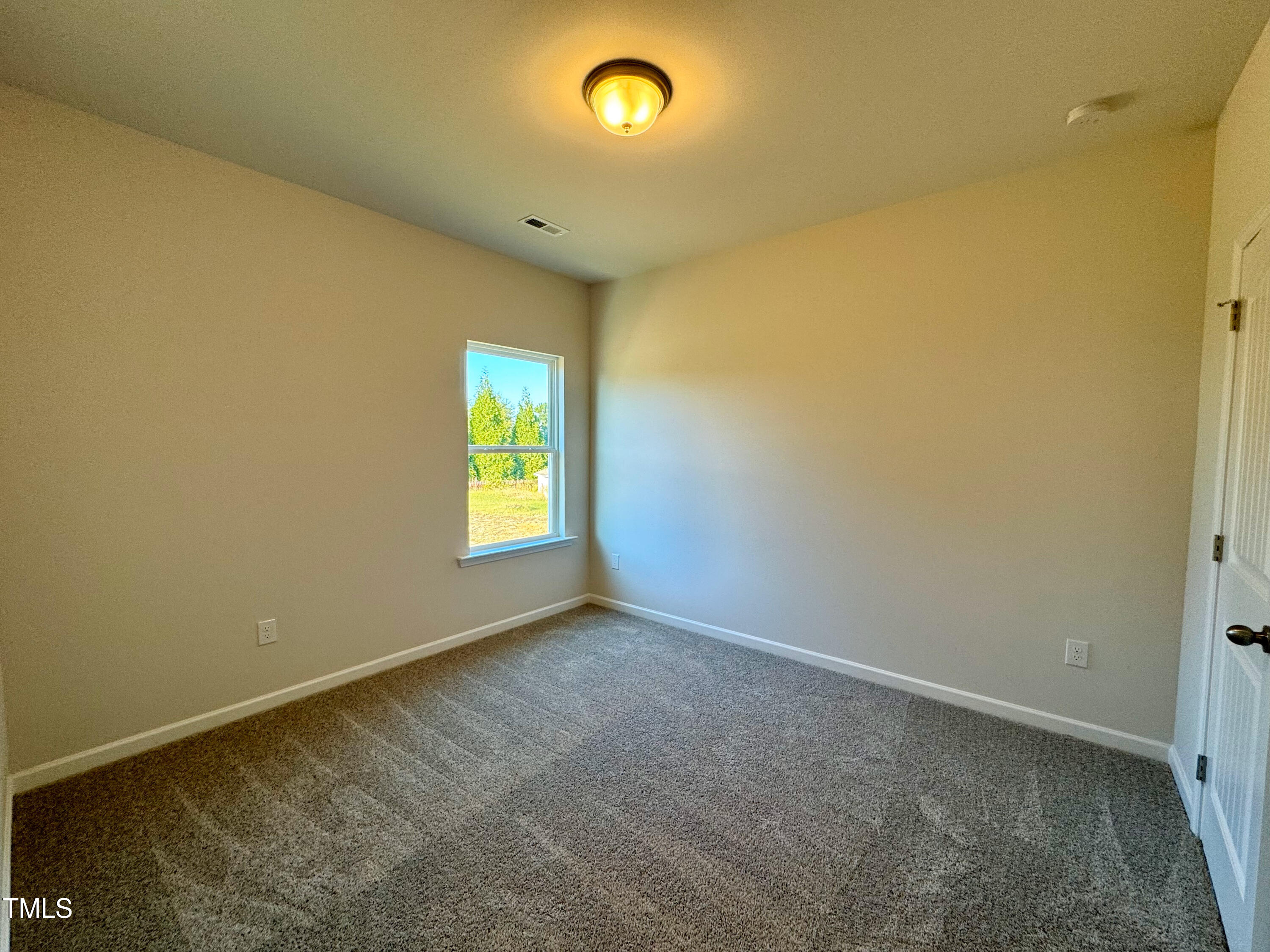 134 Commons Circle, Unit 232 Clayton, NC 27520 - Photo 20 of 37 a view of an empty room with a window