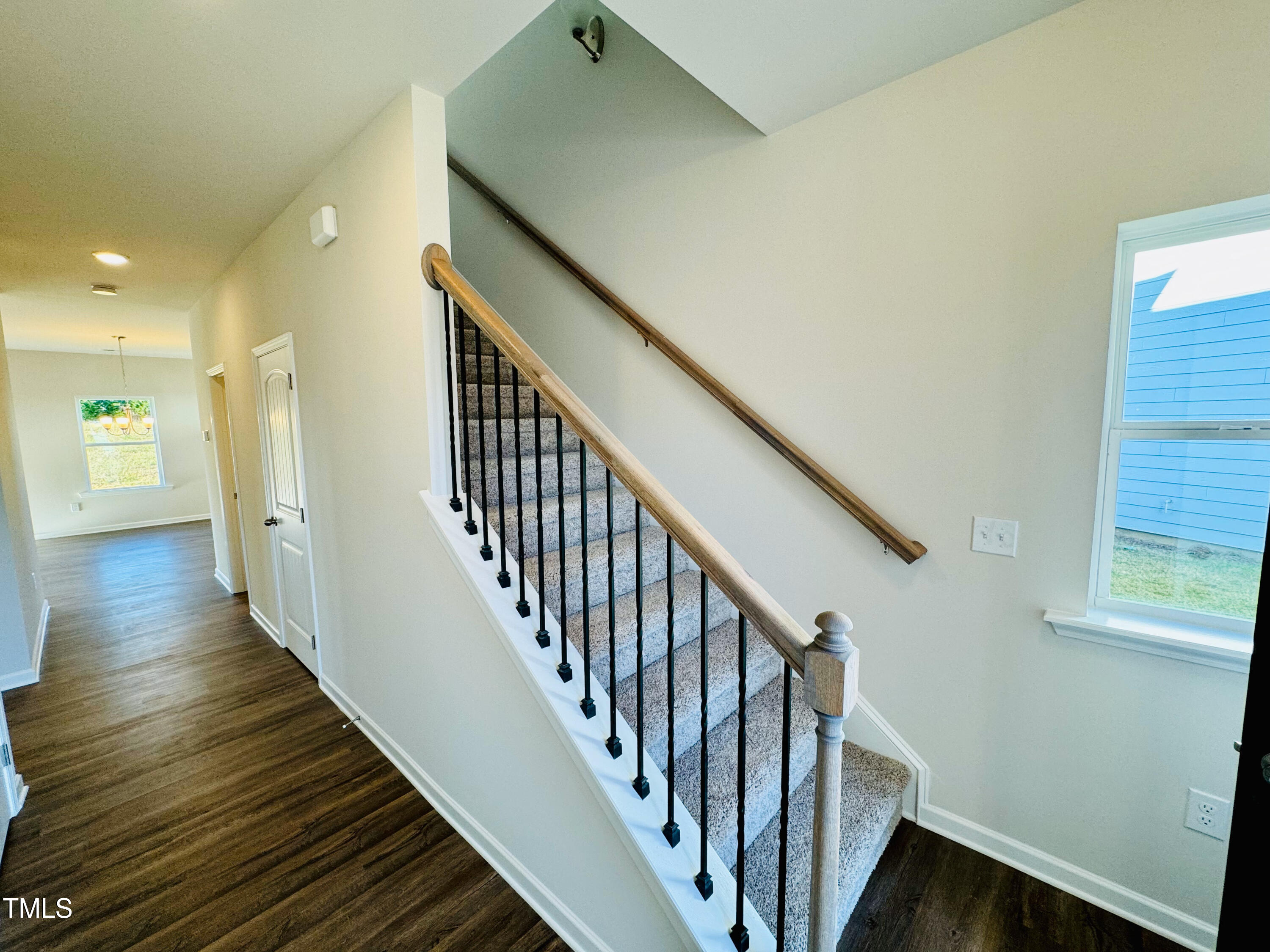 134 Commons Circle, Unit 232 Clayton, NC 27520 - Photo 2 of 37 a view of a hallway with wooden floor and staircase