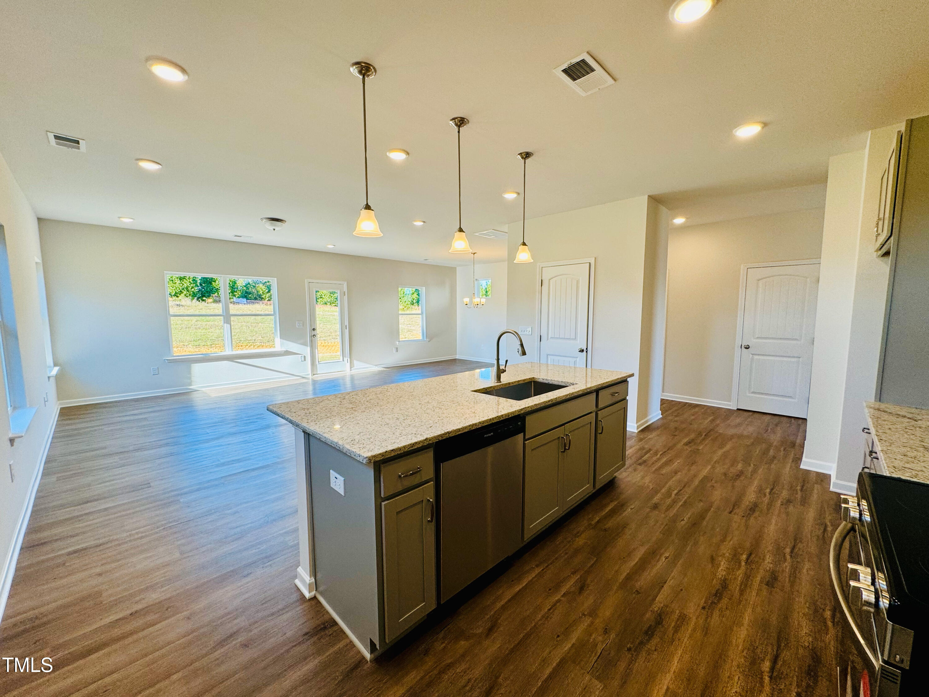 134 Commons Circle, Unit 232 Clayton, NC 27520 - Photo 6 of 37 a kitchen with a stove and wooden floor