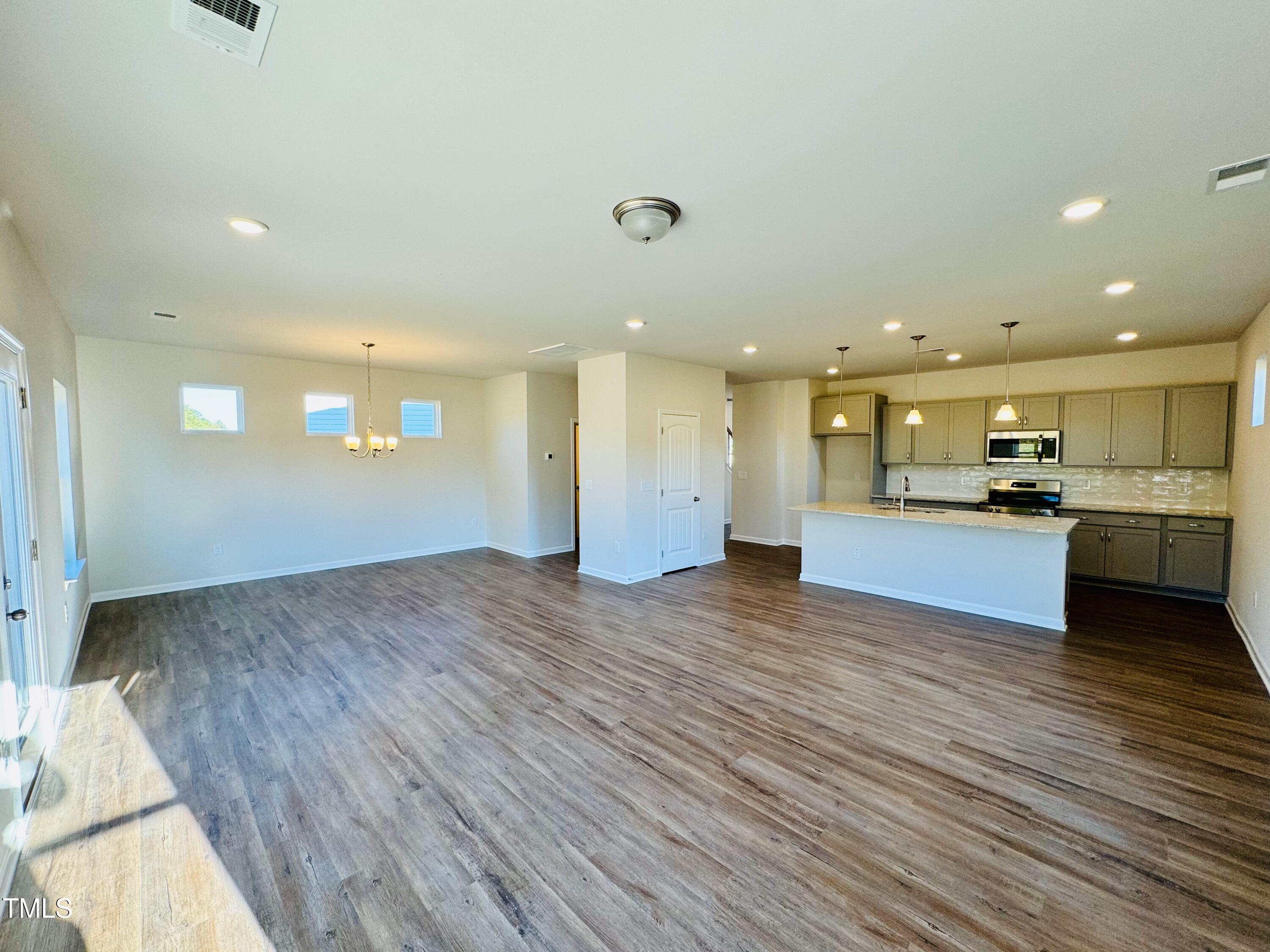 134 Commons Circle, Unit 232 Clayton, NC 27520 - Photo 7 of 37 a view of kitchen and kitchen with a decorative lights