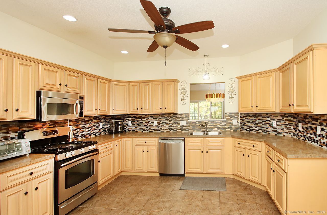 35 Todd Street, Unit 103 Hamden, CT 06518 - Photo 11 of 40 a kitchen with stainless steel appliances a stove sink and cabinets