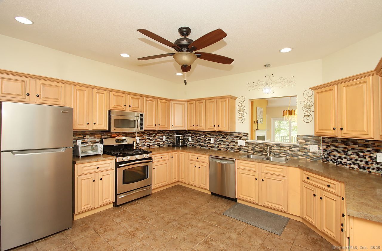 35 Todd Street, Unit 103 Hamden, CT 06518 - Photo 12 of 40 a kitchen with white cabinets and white appliances