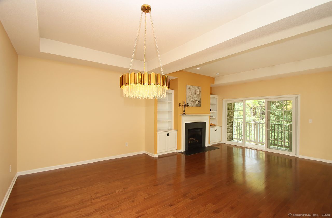 35 Todd Street, Unit 103 Hamden, CT 06518 - Photo 14 of 40 a view of a livingroom with a ceiling fan a fireplace and wooden floor