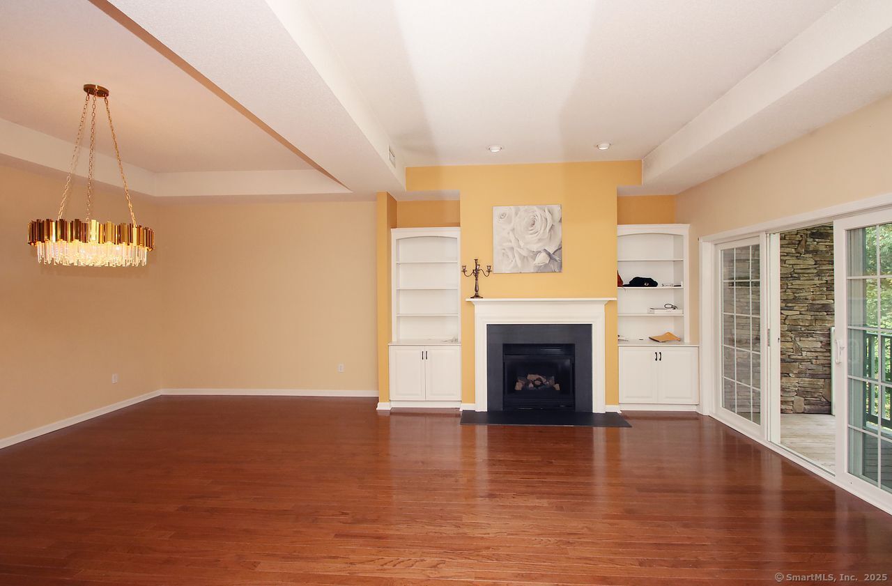 35 Todd Street, Unit 103 Hamden, CT 06518 - Photo 20 of 40 a view of a livingroom with a fireplace wooden floor and window
