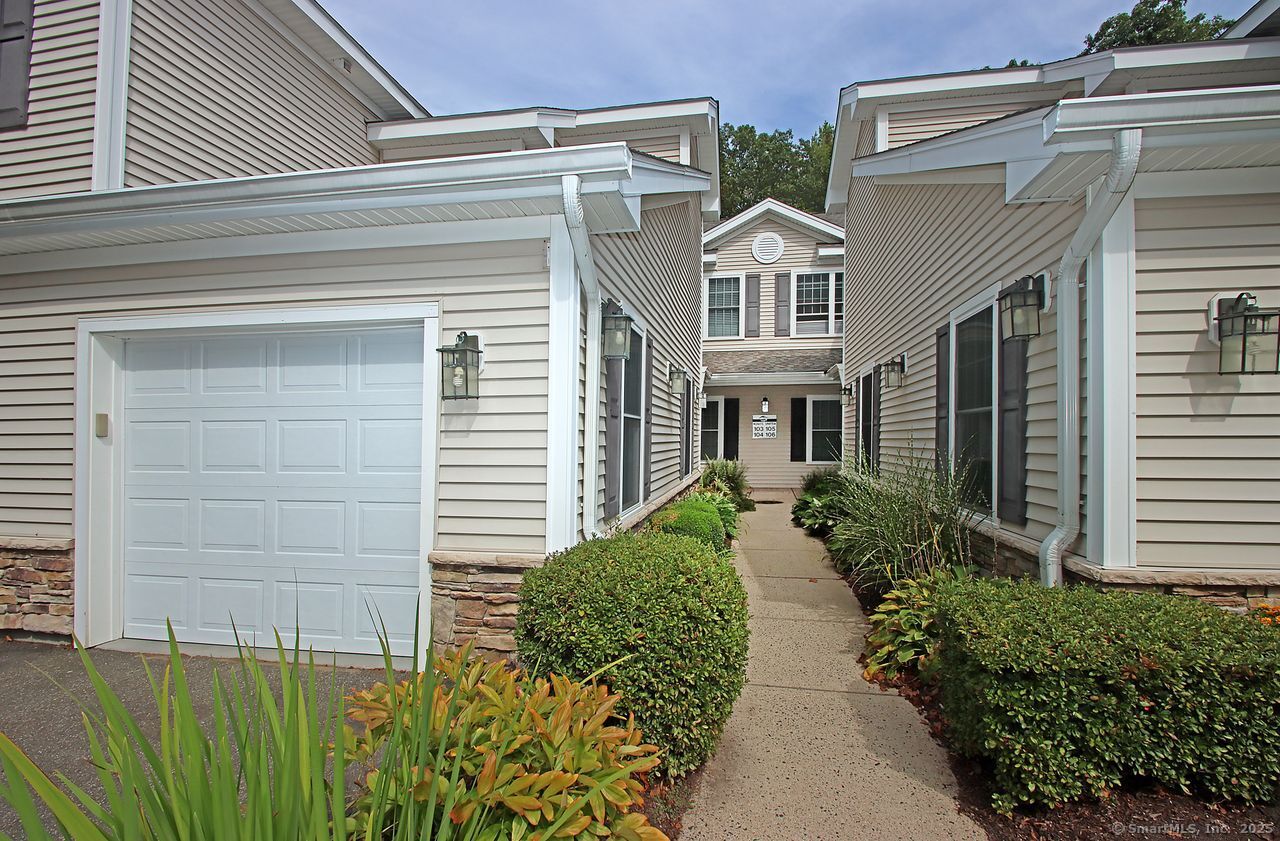 35 Todd Street, Unit 103 Hamden, CT 06518 - Photo 2 of 40 a front view of a house with garden