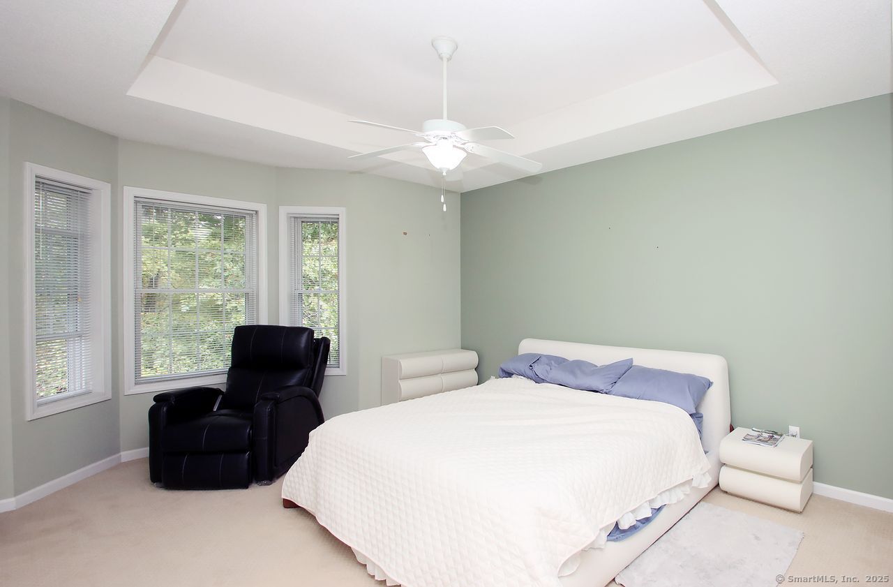 35 Todd Street, Unit 103 Hamden, CT 06518 - Photo 24 of 40 a bedroom with a bed and wooden floor
