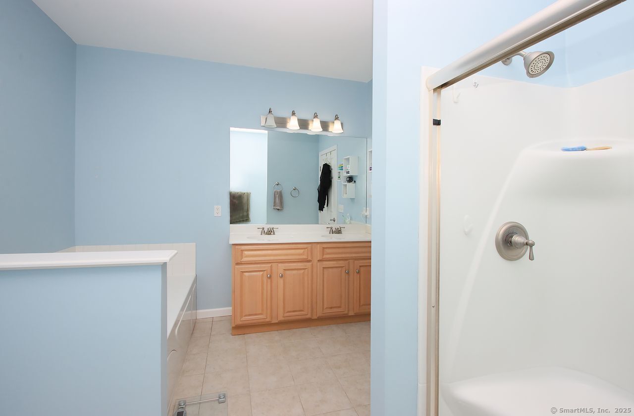35 Todd Street, Unit 103 Hamden, CT 06518 - Photo 26 of 40 a bathroom with a granite countertop sink mirror and a bathtub