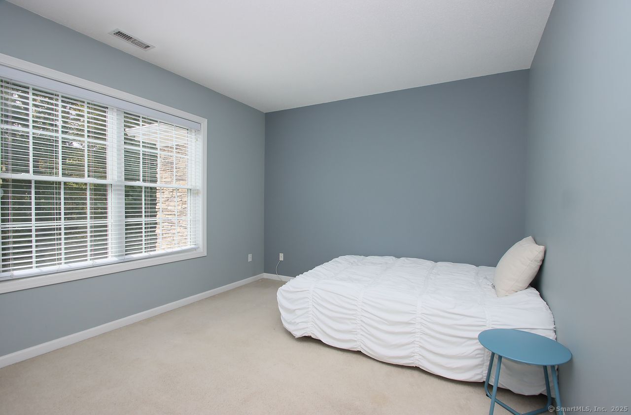 35 Todd Street, Unit 103 Hamden, CT 06518 - Photo 31 of 40 a bedroom with a bed and next to a window